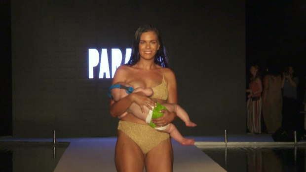 Mara Martin breastfeeds while walking the #SISwimSearch Runway